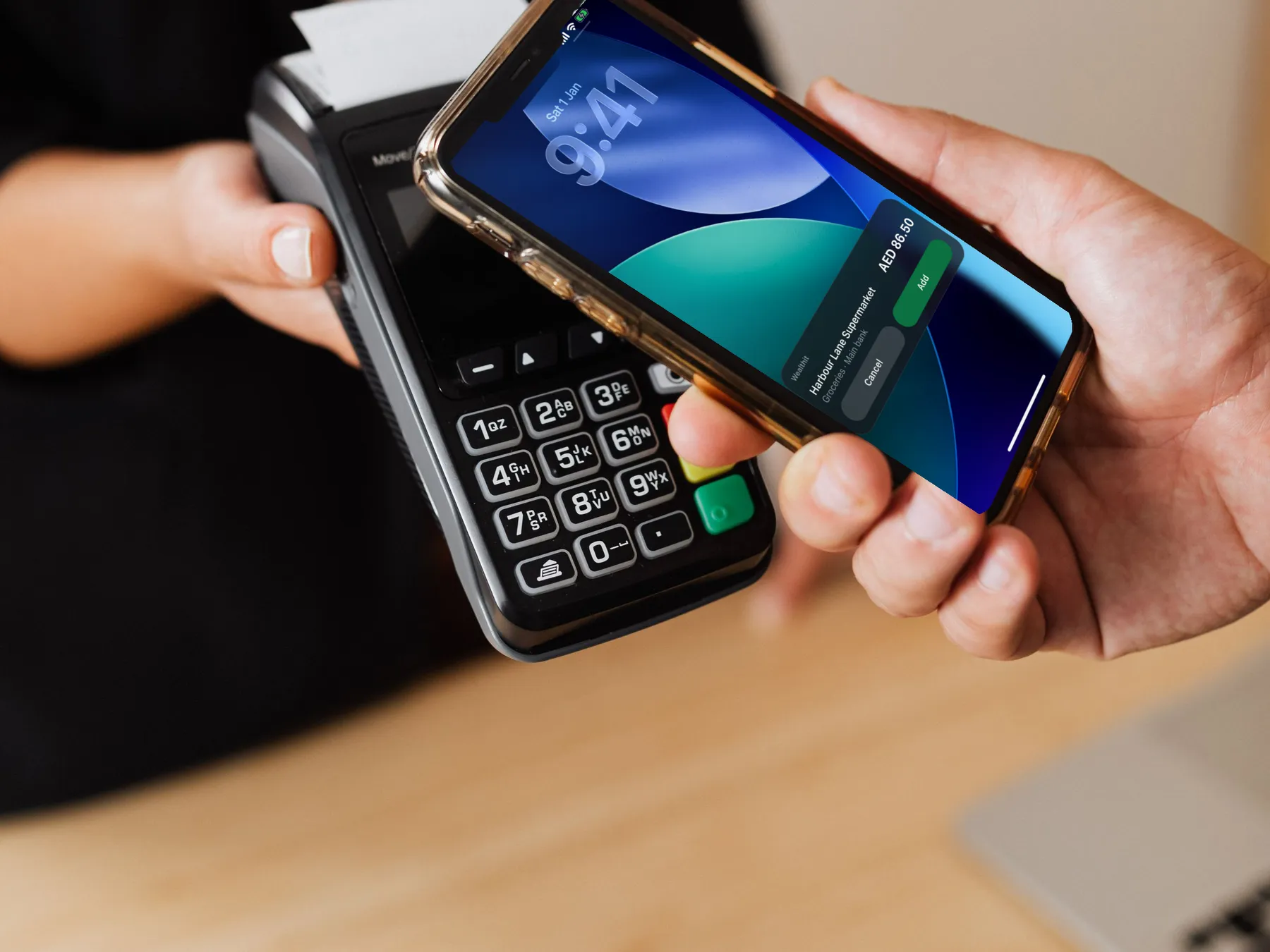 Paying at a till with an iPhone, Wealthit’s Tap to Record card on the Lock Screen: Harbour Lane Supermarket, AED 86.50, with Cancel and Add